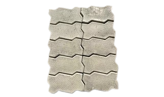 Gray interlocking concrete pavers arranged in a repeating pattern.